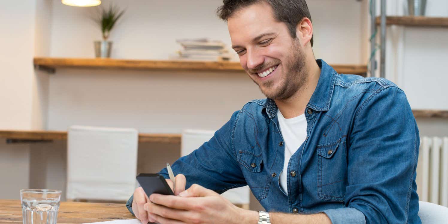 Man using smartphone at home