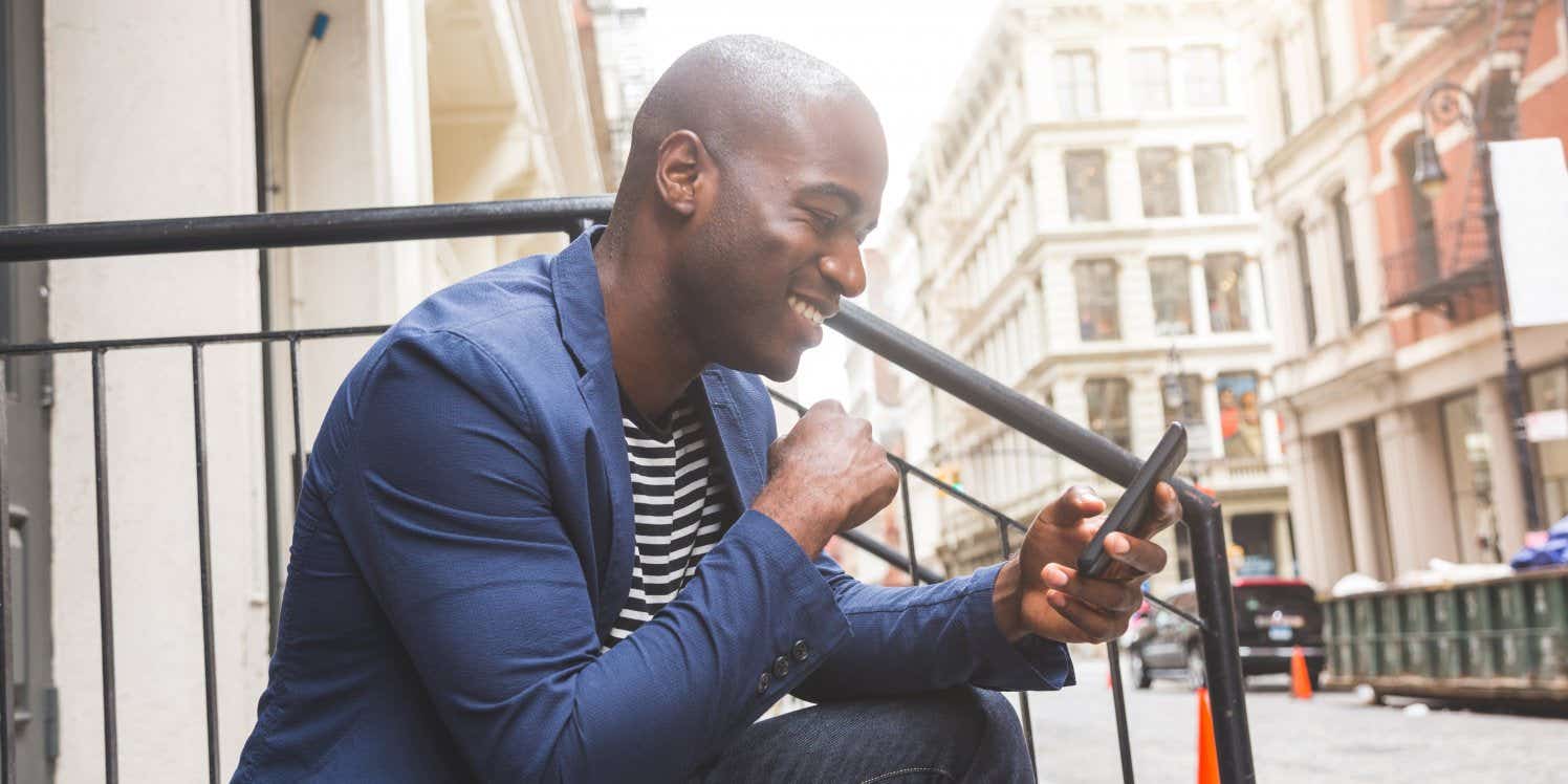 Man sitting on steps using mobile phone